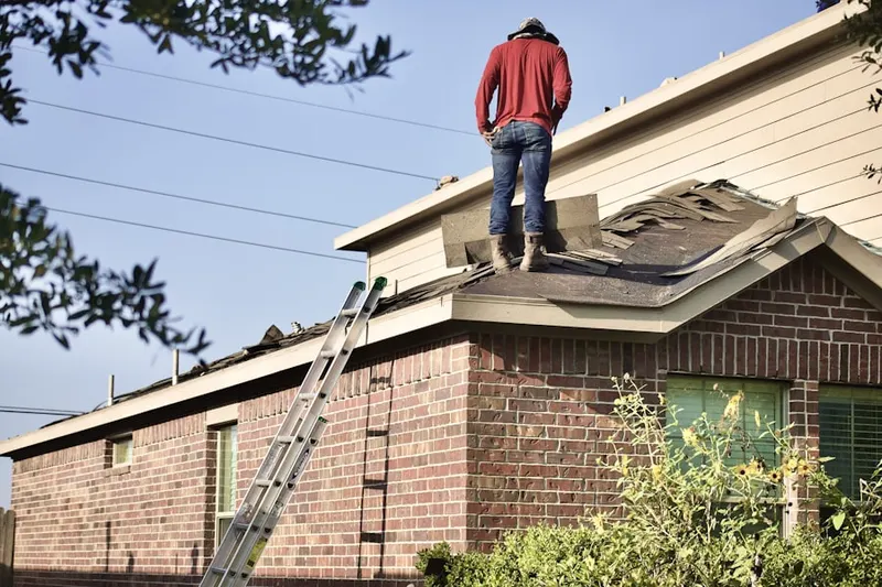 Professional roofer working on a residential roof in Old Dutch Haven